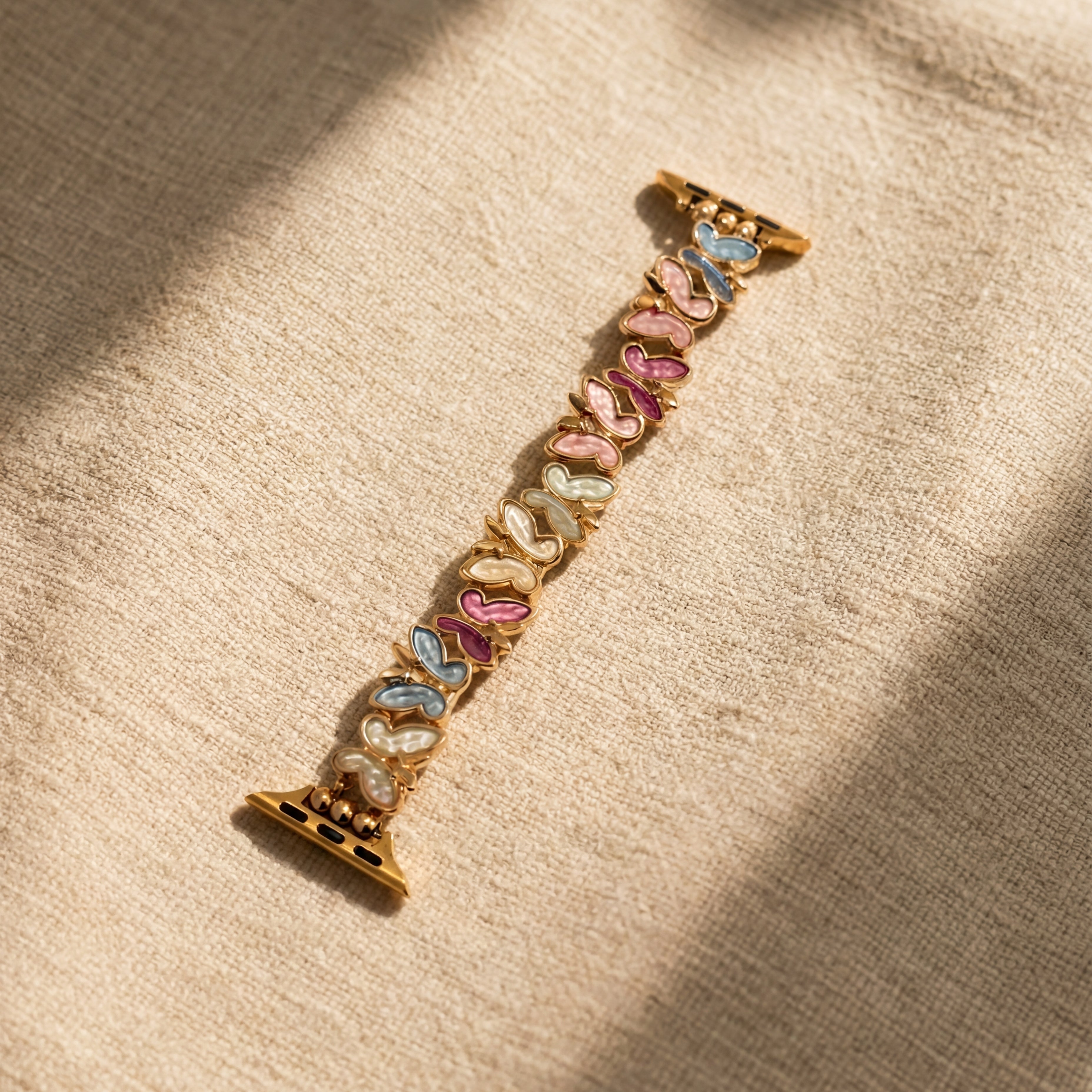 Decorative watch strap with colorful butterfly designs on a beige fabric background